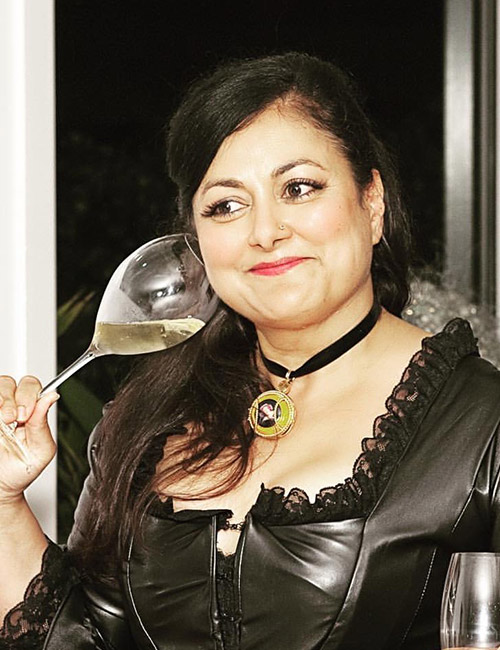 Kiron Barui Holding a Wine Glass Near Her Ear